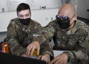 U.S. Air Force Staff Sgt. Eric Pursley, left, and Tech. Sgt. Brian Chung, right, both with the California Air National Guard's 261st Cyber Operations Squadron, run through a simulated cyber defense scenario during CyberDawn 20 in Sacramento, California, Aug. 27, 2020.  Soldiers and Airmen from the California National Guard, the Arizona National Guard and the Nevada National Guard are participating in CyberDawn 20 running across all three states. CyberDawn 20 is a two-week exercise designed to provide a tactical level cyber response to defend web based infrastructure and provide team training in Federal Emergency Management Agency Region 9. (U.S. Air National Guard photo by Tech. Sgt. Christian Jadot)