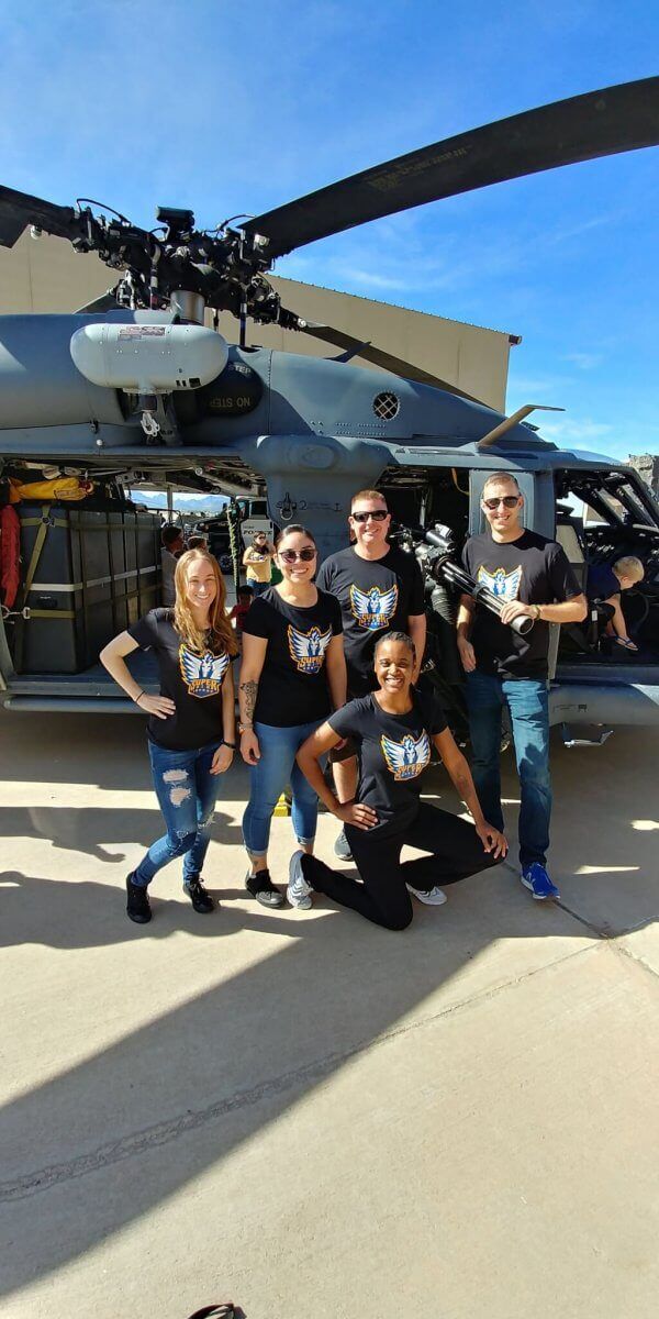 Super Six governing members pictured in front of the helicopter that rescued Navy SEAL Marcus Luttrell.