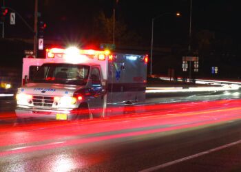 Ambulance standing in night traffic at a motor vehicle accident in early winter, Roseburg Oregon