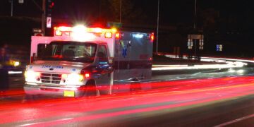 Ambulance standing in night traffic at a motor vehicle accident in early winter, Roseburg Oregon