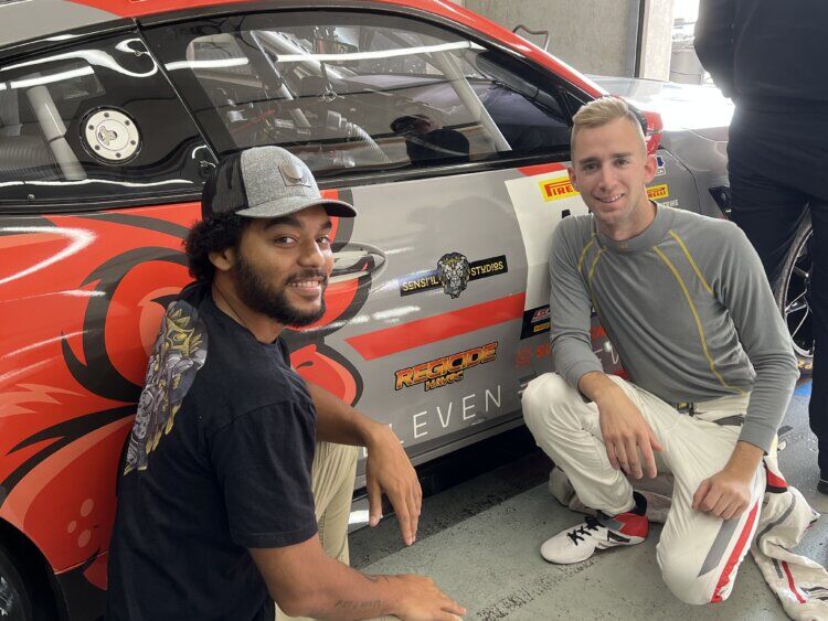 Iowa National Guardsman Spc. Aniekanabasi “Basi” White (left) pictured with NASCAR driver Colin Garrett
